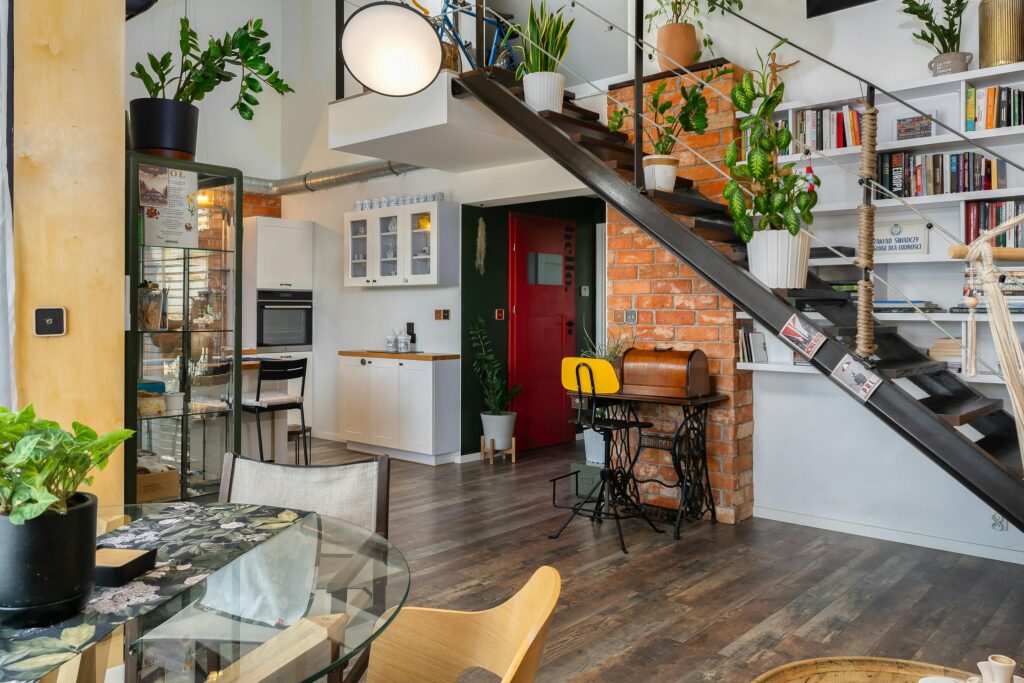 Stylish loft apartment interior featuring a blend of modern design and lush greenery.